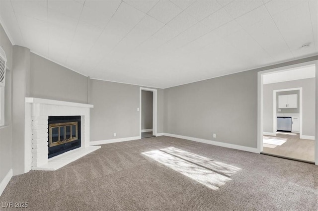 unfurnished living room featuring carpet flooring and a fireplace