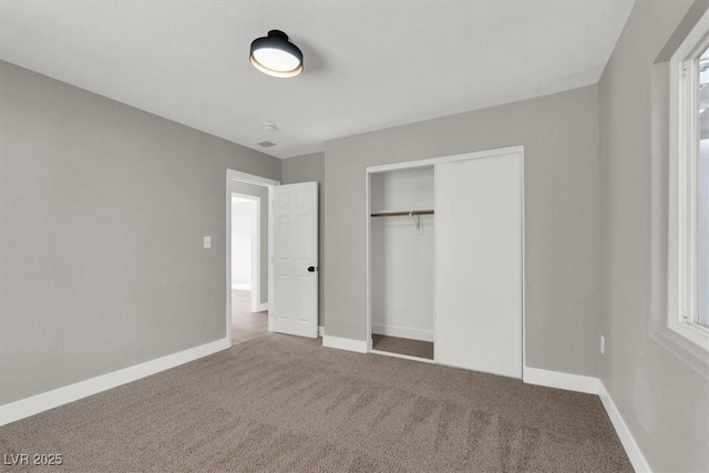 unfurnished bedroom with carpet floors and a closet