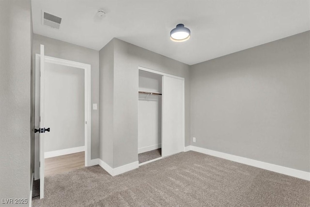 unfurnished bedroom with carpet floors and a closet