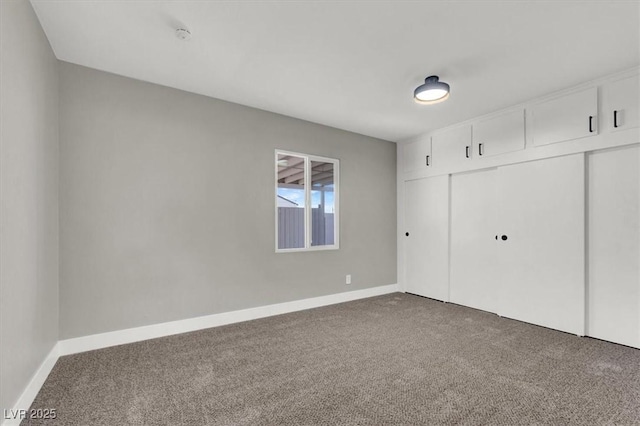 unfurnished bedroom featuring carpet floors and a closet