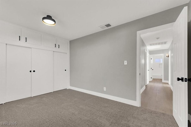 unfurnished bedroom featuring carpet floors and a closet