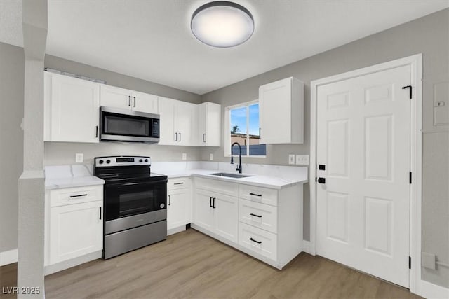 kitchen featuring white cabinetry, appliances with stainless steel finishes, and sink