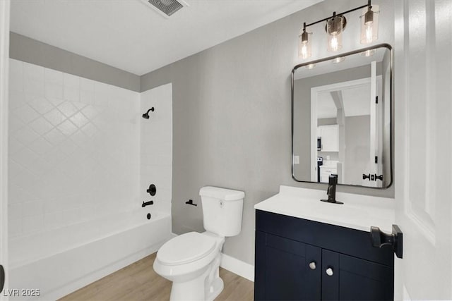 full bathroom featuring vanity, wood-type flooring, shower / bathtub combination, and toilet