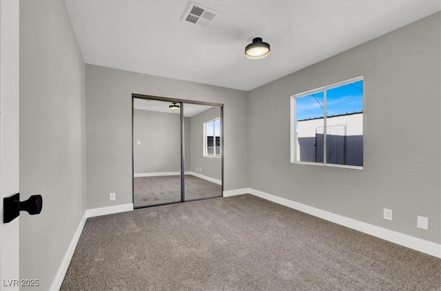 unfurnished bedroom with carpet floors and a closet