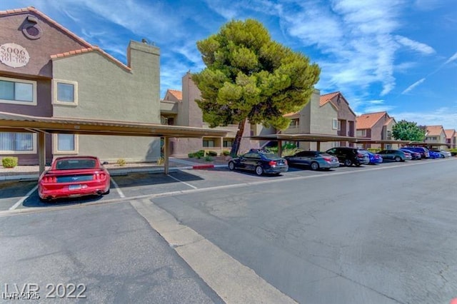 view of vehicle parking featuring a carport