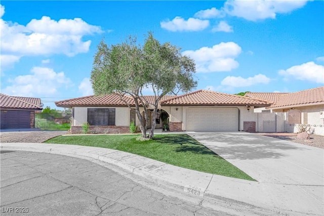 mediterranean / spanish-style house with a garage and a front lawn