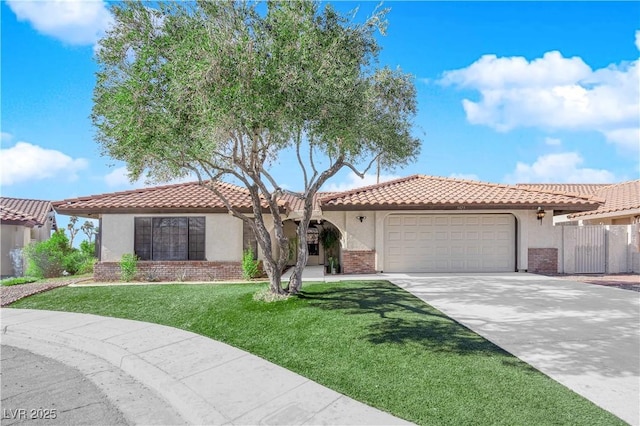 mediterranean / spanish house with a garage and a front yard