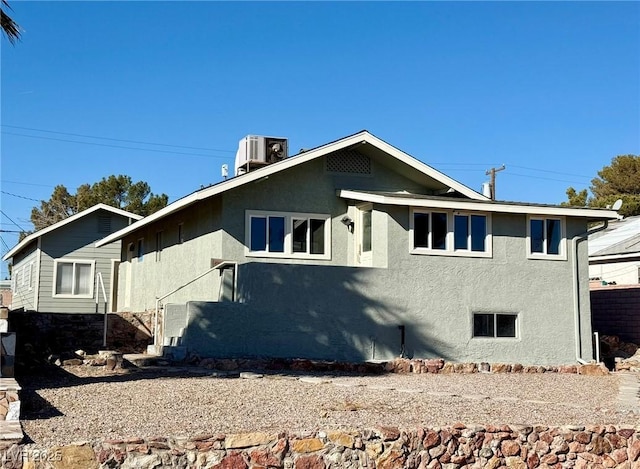 rear view of house featuring central AC