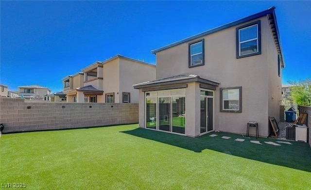 rear view of property featuring a yard