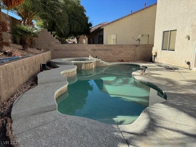 view of swimming pool featuring an in ground hot tub and a patio