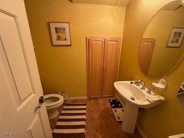 bathroom with tile patterned floors and toilet