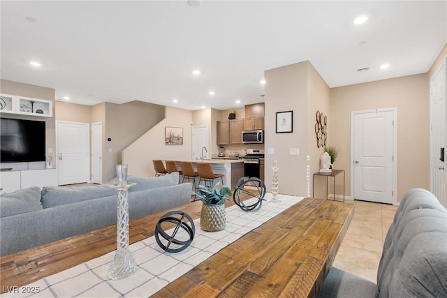 tiled living room featuring sink