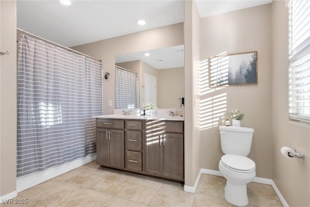 bathroom featuring vanity, tile patterned flooring, toilet, and walk in shower