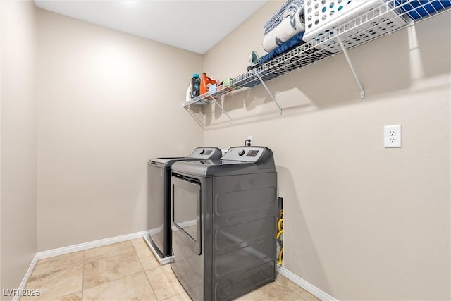 laundry area with tile patterned floors and independent washer and dryer