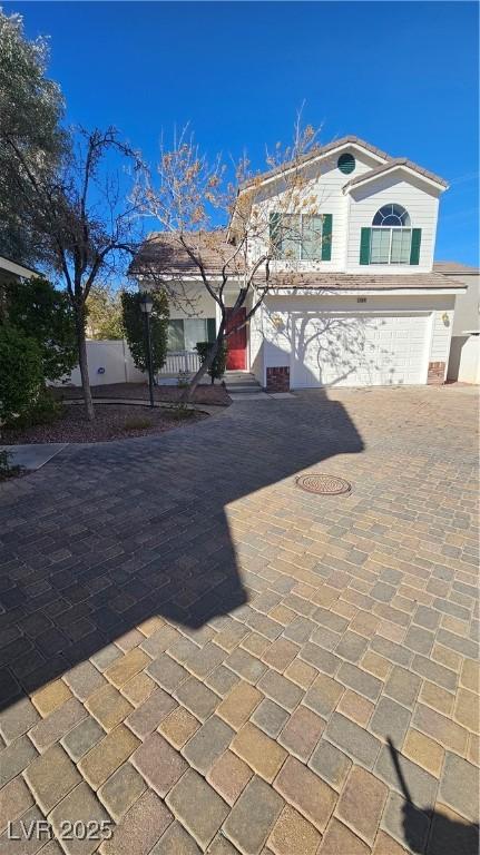 view of front of home featuring decorative driveway and an attached garage