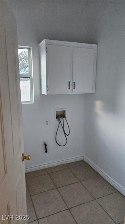 laundry room with cabinet space, light tile patterned floors, hookup for a washing machine, and baseboards