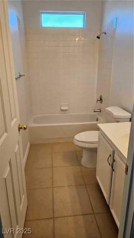 bathroom with bathing tub / shower combination, toilet, vanity, and tile patterned flooring