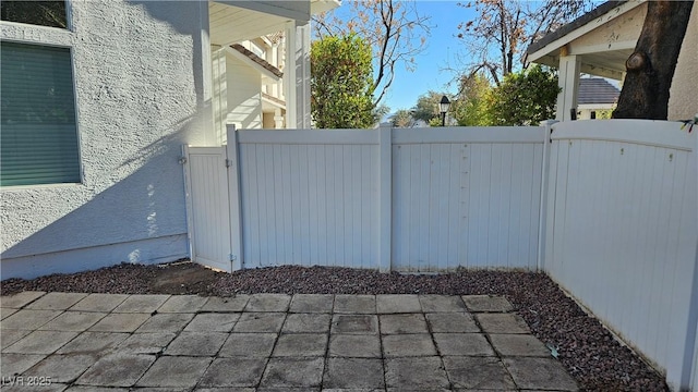 view of patio with fence and a gate