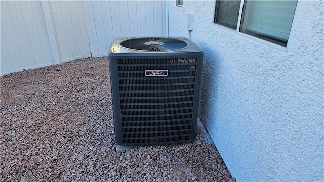 details featuring cooling unit and stucco siding