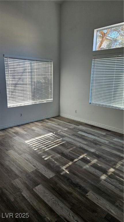 empty room with wood finished floors and baseboards