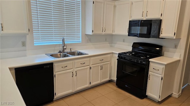 kitchen with black appliances, white cabinets, light countertops, and a sink