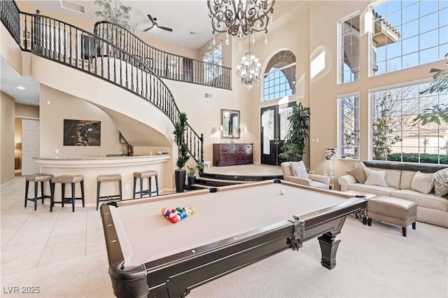 playroom featuring visible vents, billiards, an inviting chandelier, light tile patterned floors, and a towering ceiling