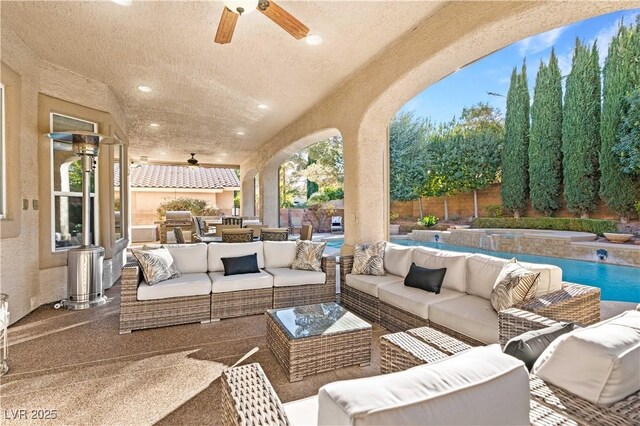 view of patio with a fenced in pool, outdoor lounge area, and ceiling fan