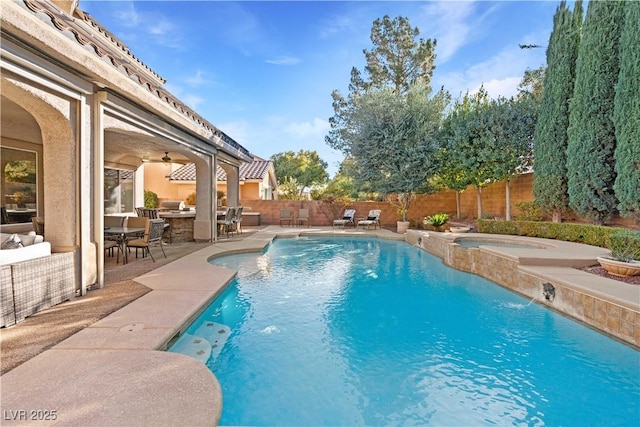 view of swimming pool featuring a patio, a fenced backyard, a fenced in pool, and an in ground hot tub