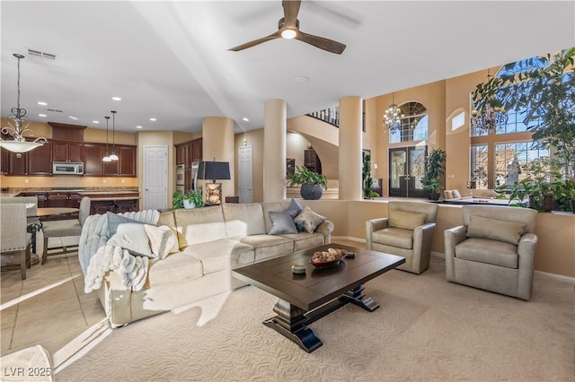 living room featuring light tile patterned floors and ceiling fan