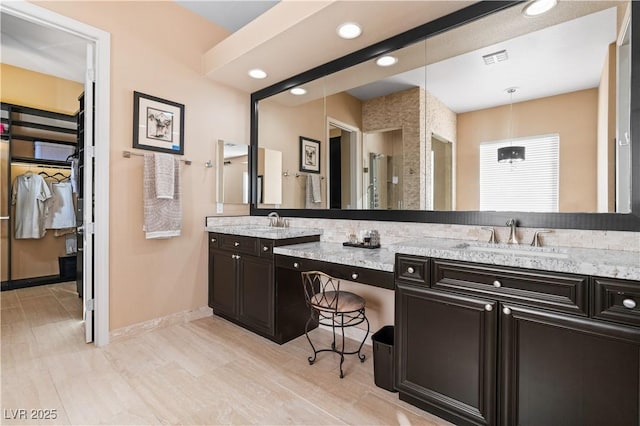 full bath with double vanity, visible vents, recessed lighting, and a sink