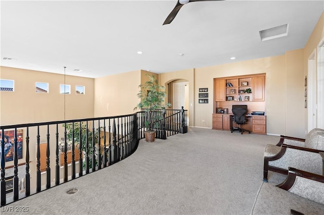 living area featuring visible vents, recessed lighting, arched walkways, carpet flooring, and ceiling fan