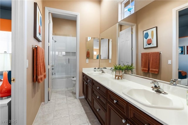 full bathroom with tile patterned flooring, vanity, combined bath / shower with glass door, and toilet