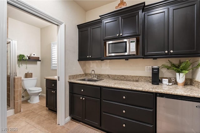 kitchen featuring light tile patterned flooring, fridge, and sink