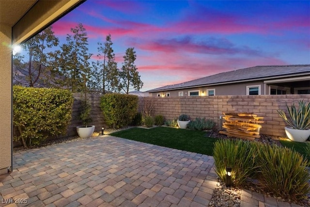 view of patio terrace at dusk