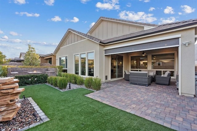 rear view of house featuring a yard, an outdoor hangout area, a patio, and ceiling fan