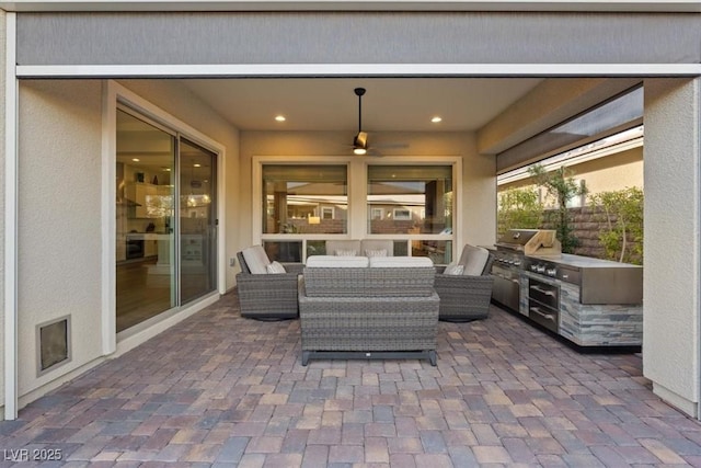 view of patio featuring exterior kitchen, a grill, and an outdoor hangout area