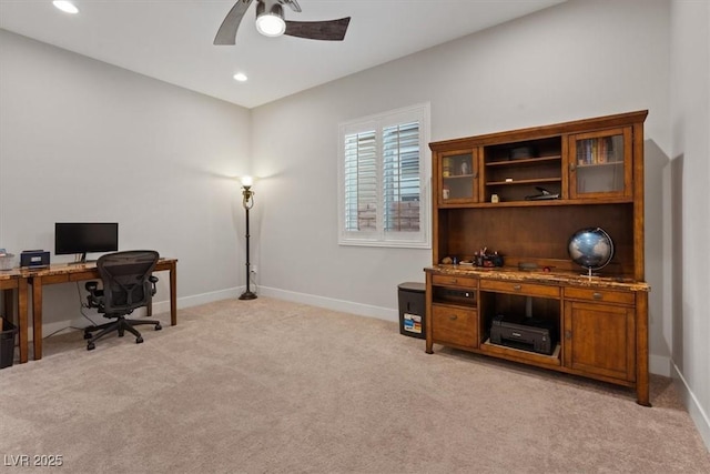 carpeted office featuring ceiling fan