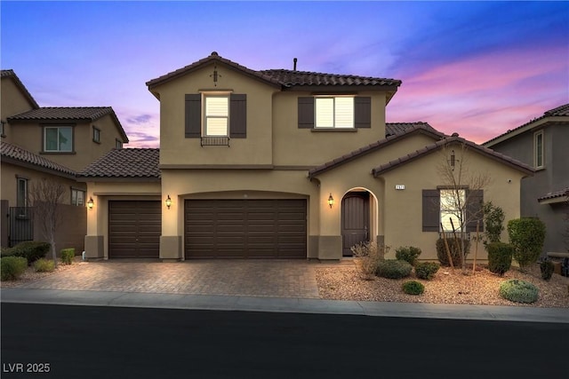 mediterranean / spanish-style house featuring a garage