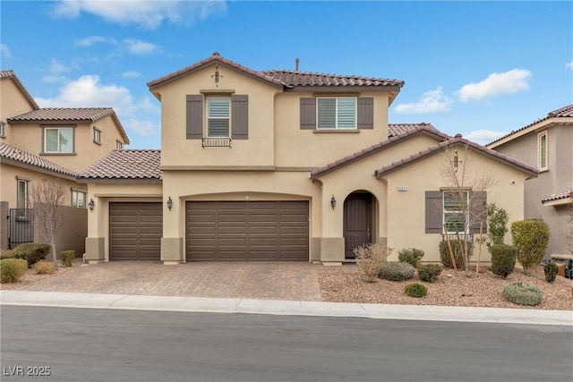 mediterranean / spanish-style home with a garage