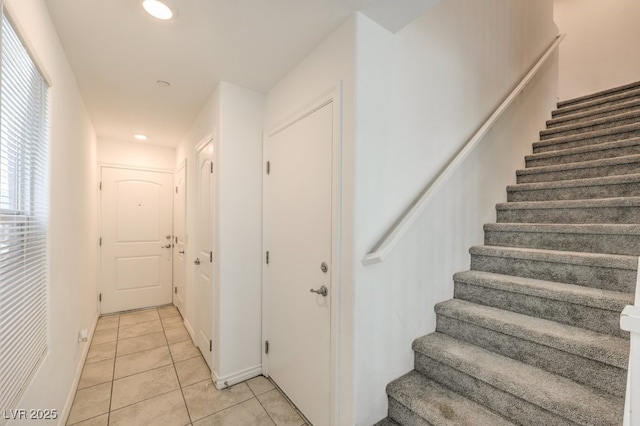 stairway with tile patterned flooring