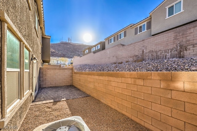 view of yard with central AC unit and a patio area