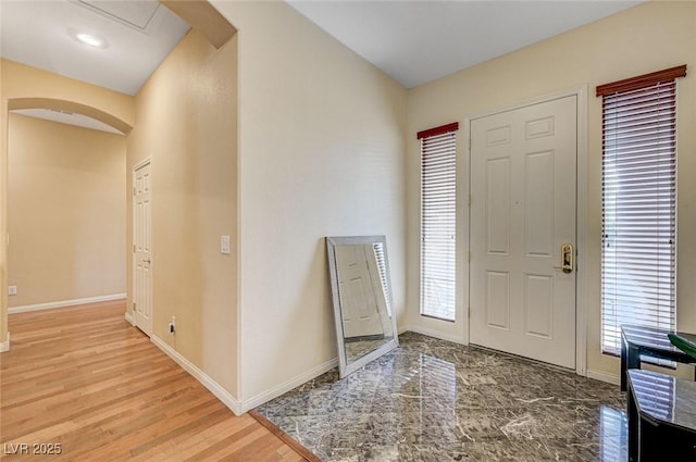 entrance foyer with hardwood / wood-style flooring and a healthy amount of sunlight