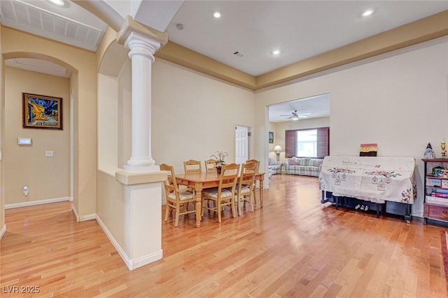 dining room featuring decorative columns and light hardwood / wood-style floors