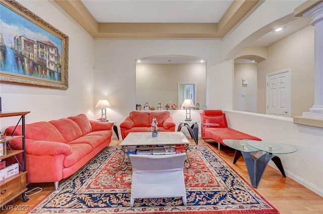 living room featuring hardwood / wood-style floors and ornate columns