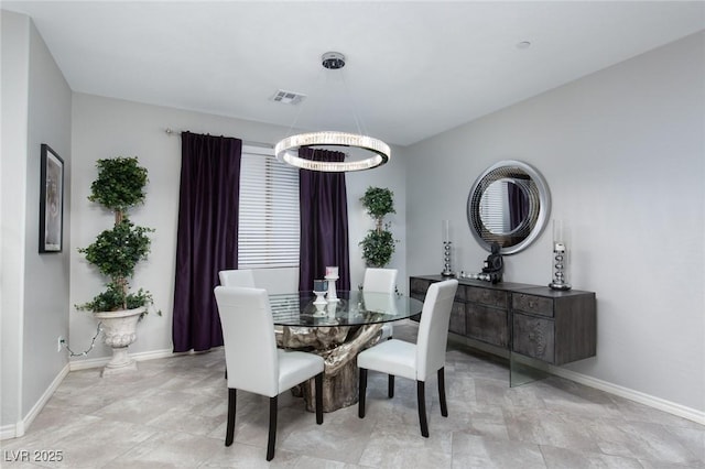 dining area featuring a chandelier, visible vents, and baseboards