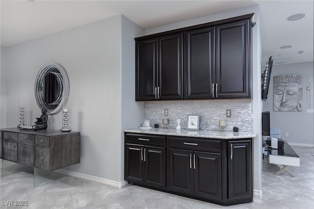 bar with baseboards and decorative backsplash