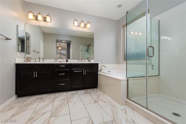 full bath featuring a stall shower, a garden tub, and a sink