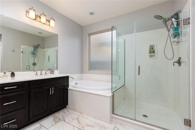 full bath featuring a stall shower, marble finish floor, a bath, and vanity