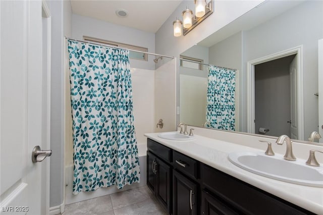 bathroom with double vanity, shower / bathtub combination with curtain, a sink, and tile patterned floors