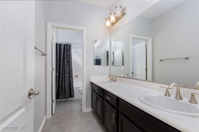 bathroom featuring toilet, tile patterned flooring, double vanity, and a sink